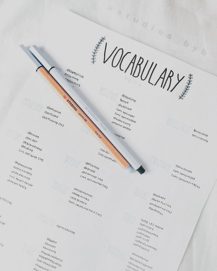 a pen sitting on top of a sheet of paper with the word vocabulary written in it