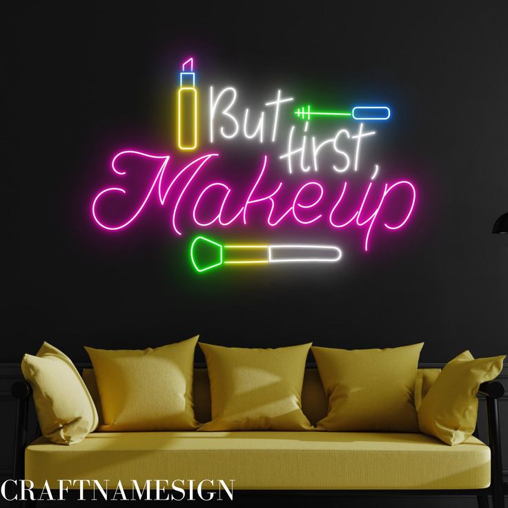 a neon sign that says, but first make up on the wall above a couch