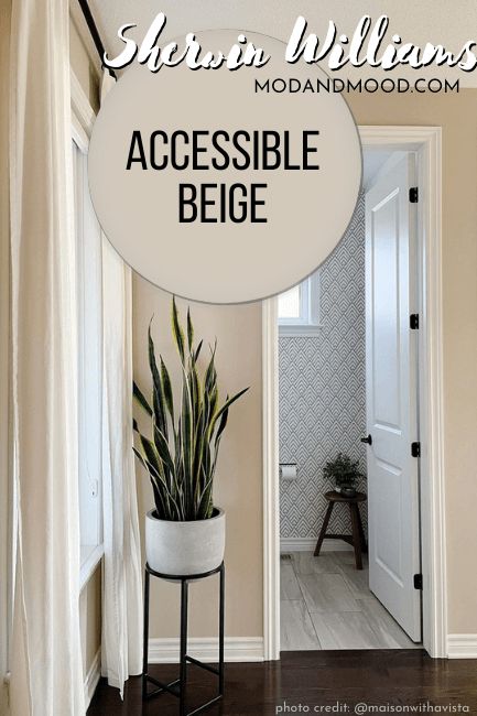 there is a white door with the words accessible beige on it and a potted plant