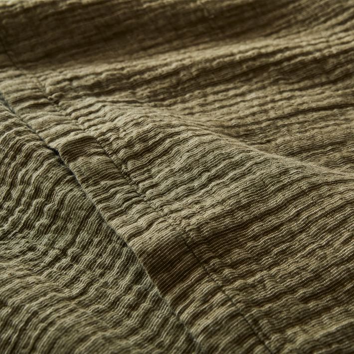 a close up view of the textured fabric on a bed sheet that has been made with