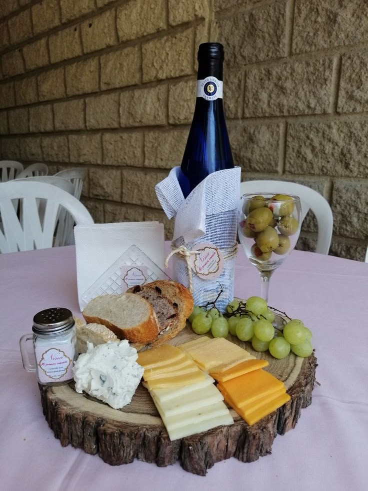 a wine bottle and cheese plate on a table