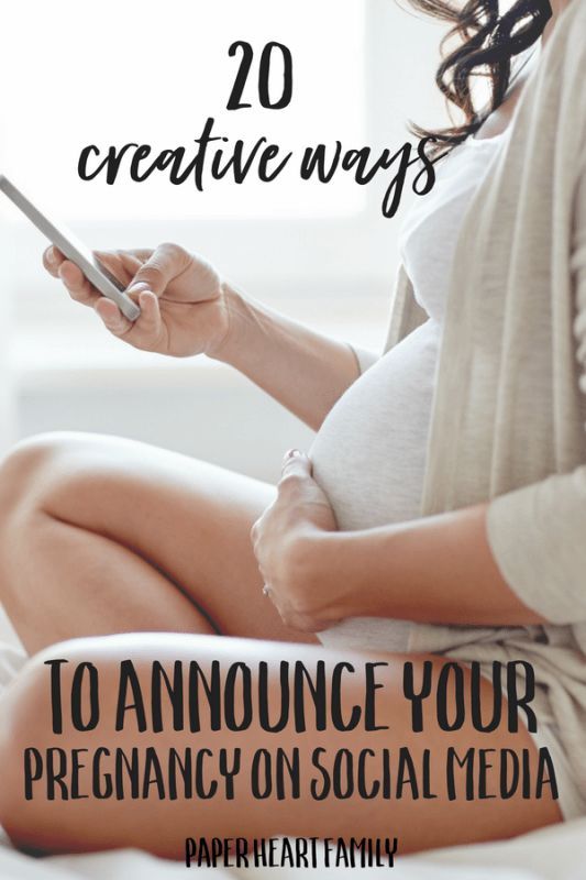 a pregnant woman sitting on her bed looking at her phone with the caption 20 creative ways to announce your pregnant on social media