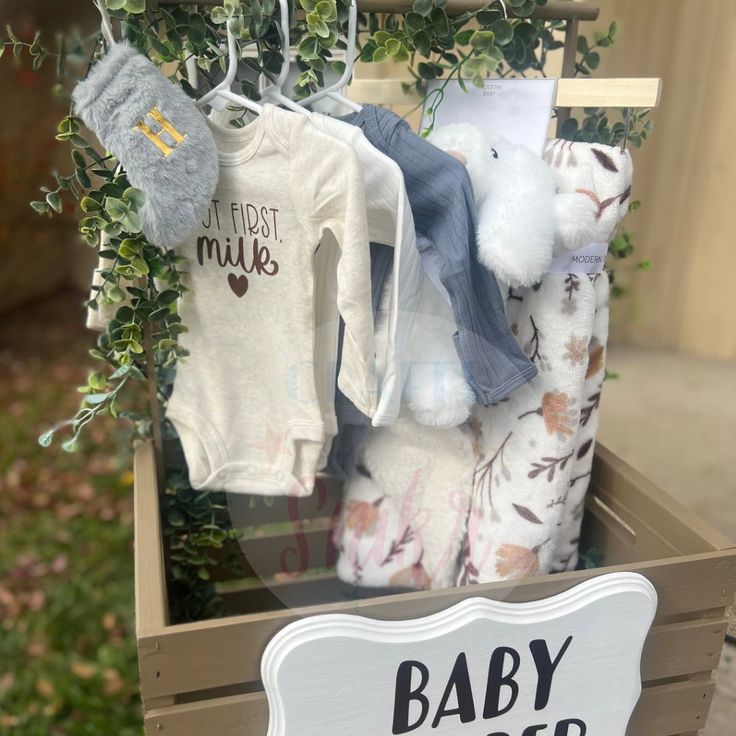 a box with baby clothes hanging from it's sides