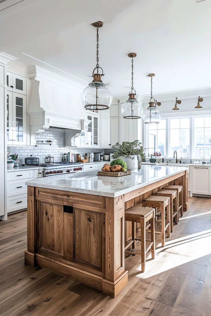 a large kitchen island with stools in the middle and an island on one side