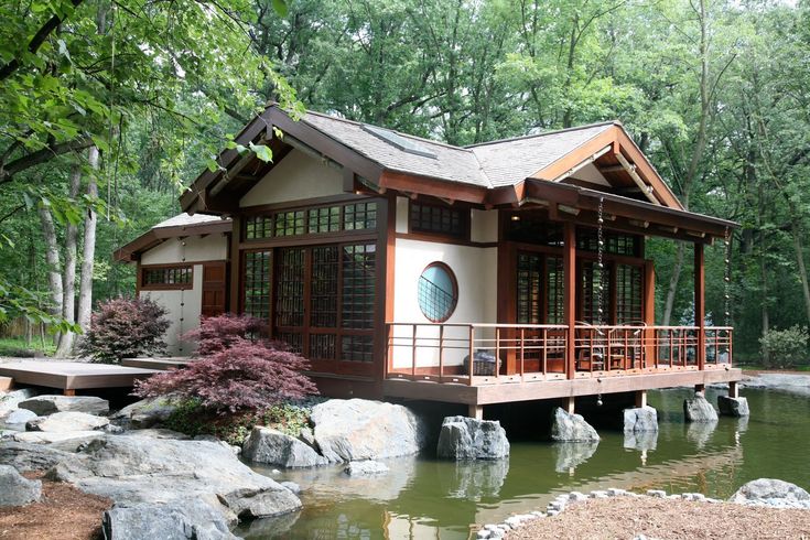 a small house sitting on top of a pond