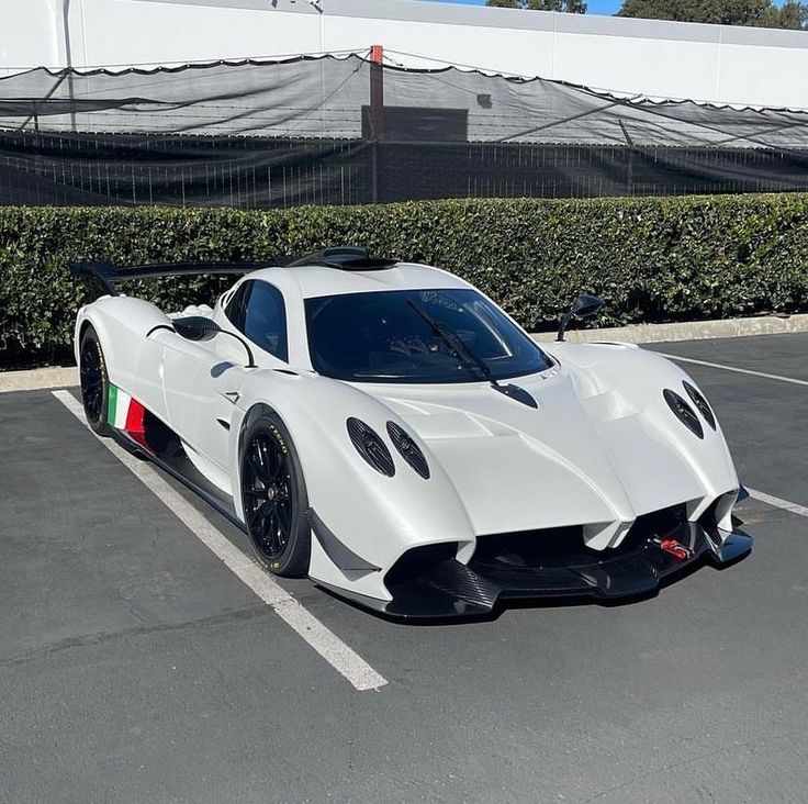 a white sports car parked in a parking lot