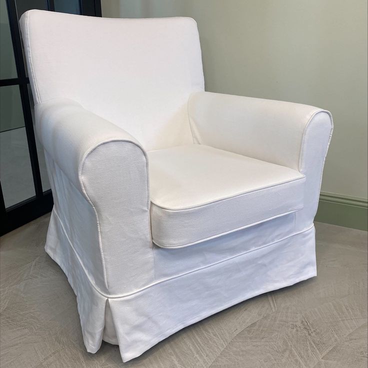 a white chair sitting on top of a hard wood floor