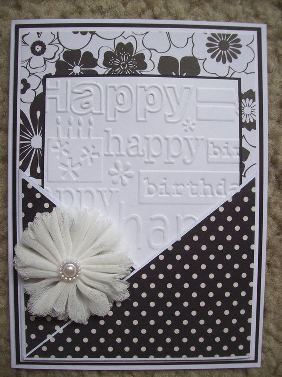 a happy birthday card with a flower and polka dot paper on the bottom, in black and white