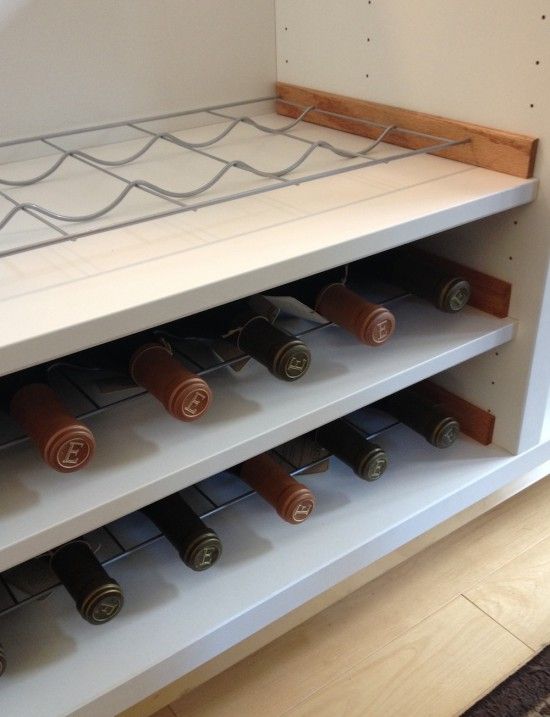 a wine rack with many bottles in it