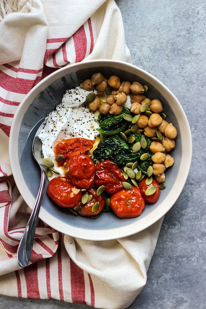 a bowl with tomatoes, spinach and chickpeas