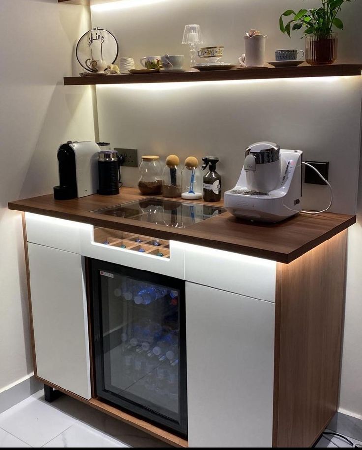 a kitchen counter with a wine cooler underneath it