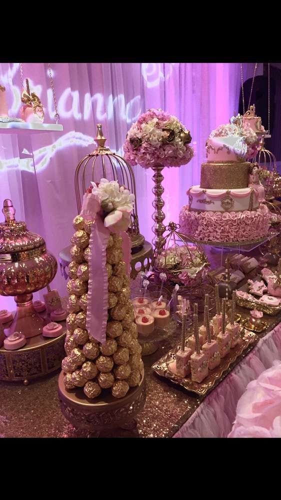 a table topped with lots of cakes and desserts