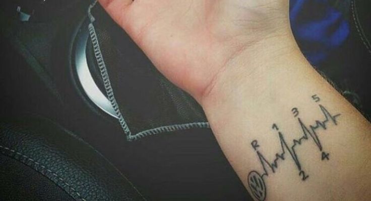 a hand with a heartbeat tattoo on it