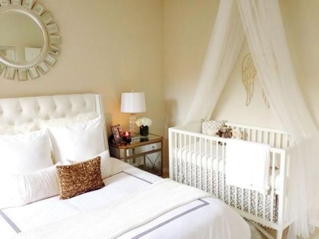 a white crib in the corner of a room next to a dresser and mirror