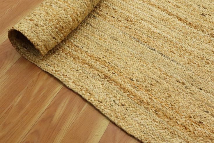 a close up view of a rug on the floor with wood floors in the background