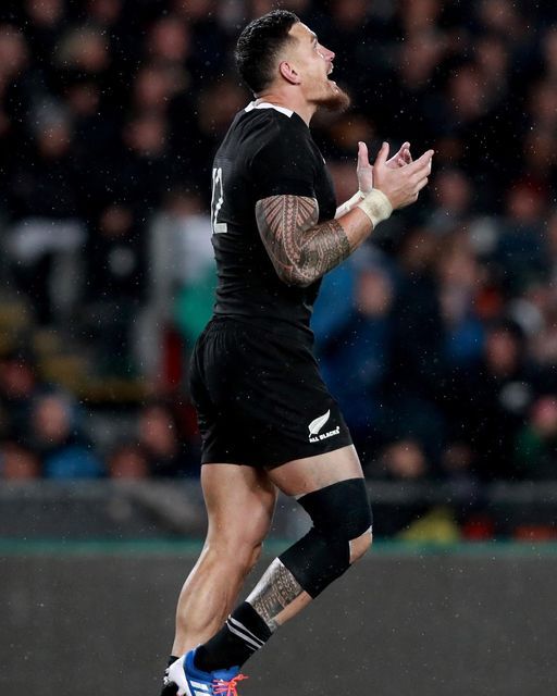 a rugby player catching a ball in the air