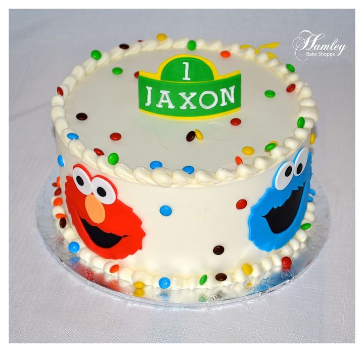 a birthday cake decorated with sesame street characters