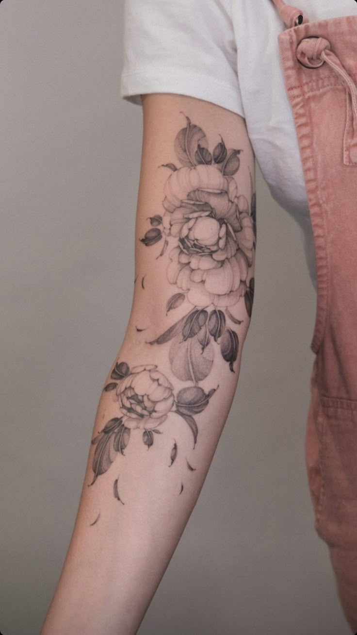 a woman with a flower tattoo on her arm