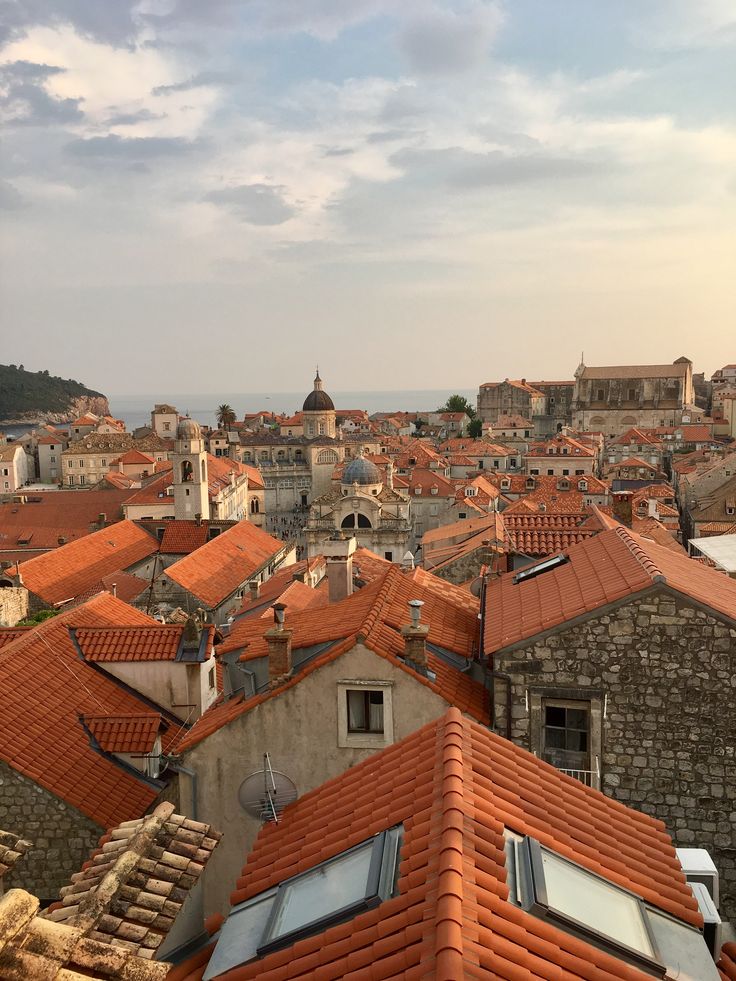 the rooftops of an old city with red tiled roofs