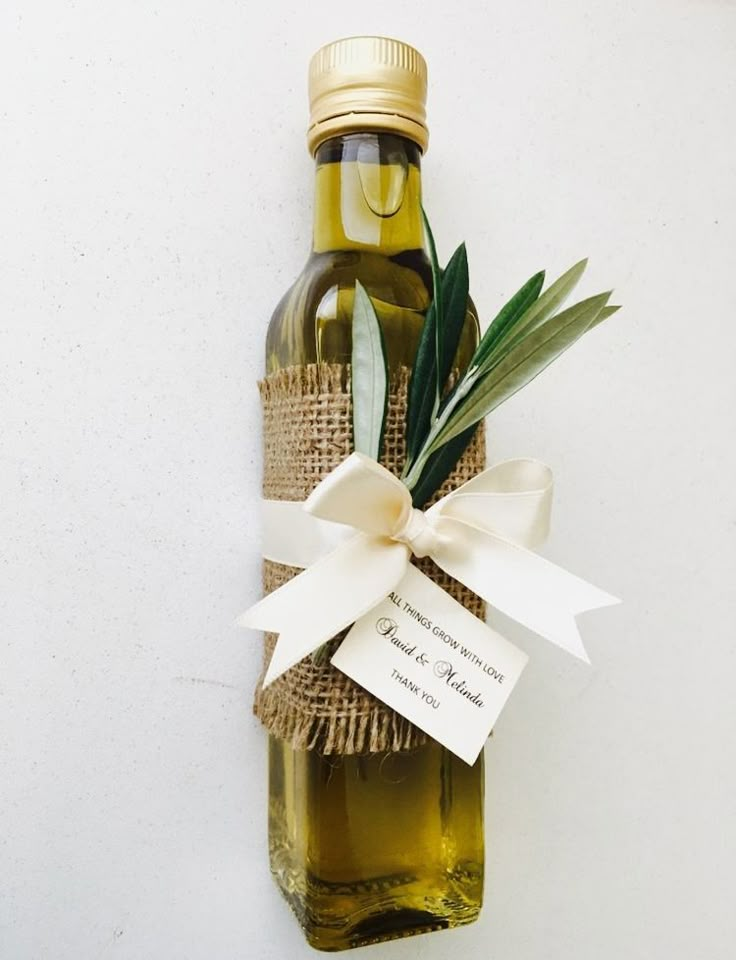 an olive oil bottle wrapped in twine and tied with a white ribbon