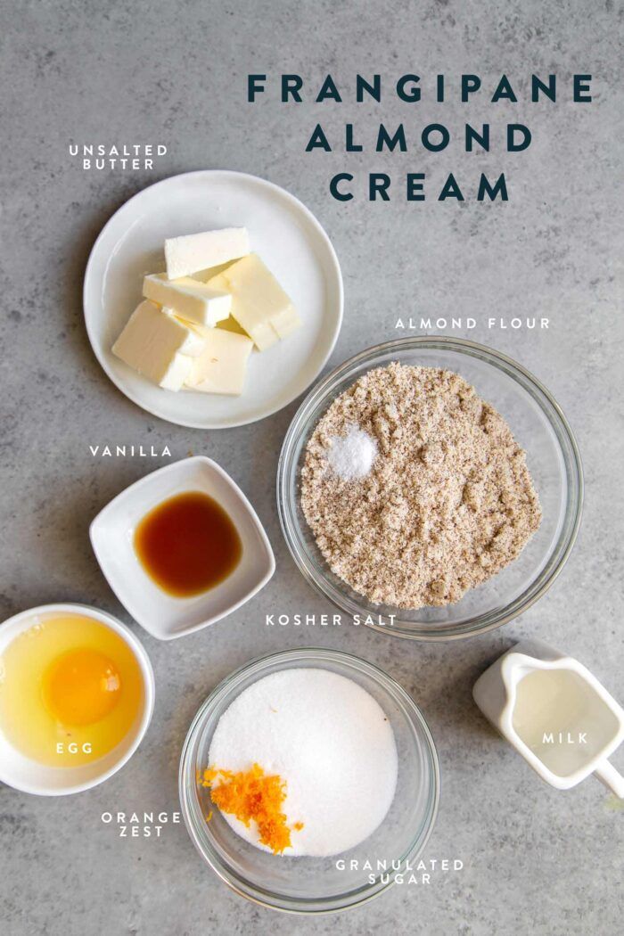 ingredients to make franigipee almond cream in bowls on a gray countertop