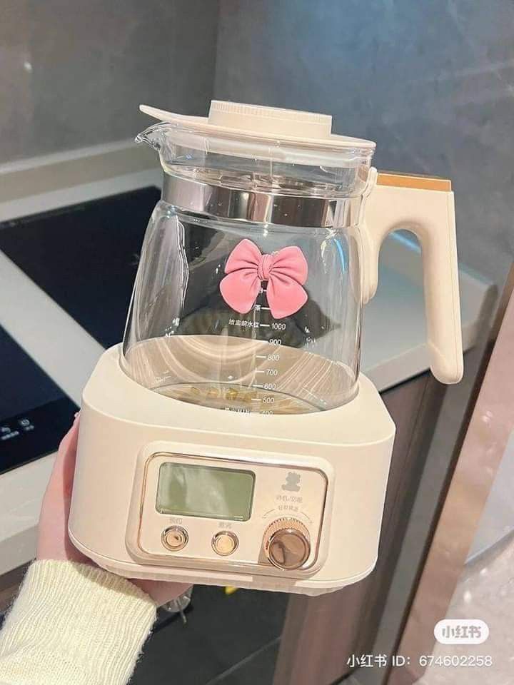 a person holding a blender with a pink bow on it