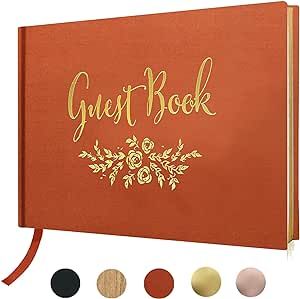 an orange guest book with gold lettering on the front and four different colored circles around it