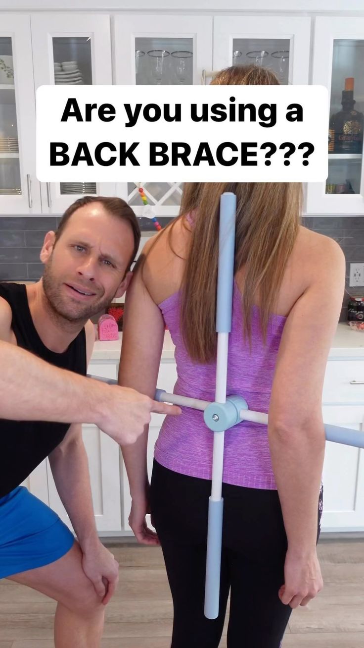 a man and woman standing next to each other in front of a kitchen counter with the words are you using a back brace?