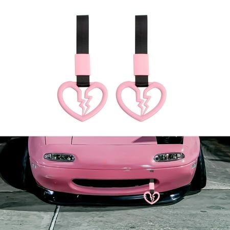 two pink cars with heart shaped lights on the front and rear bumpers, one is in