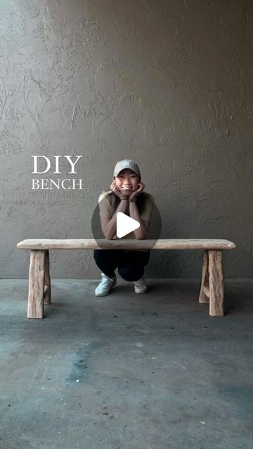 a man sitting on top of a wooden bench next to a gray wall with the words diy bench