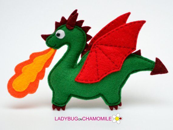 a green and red toy dragon with a flame coming out of it's mouth