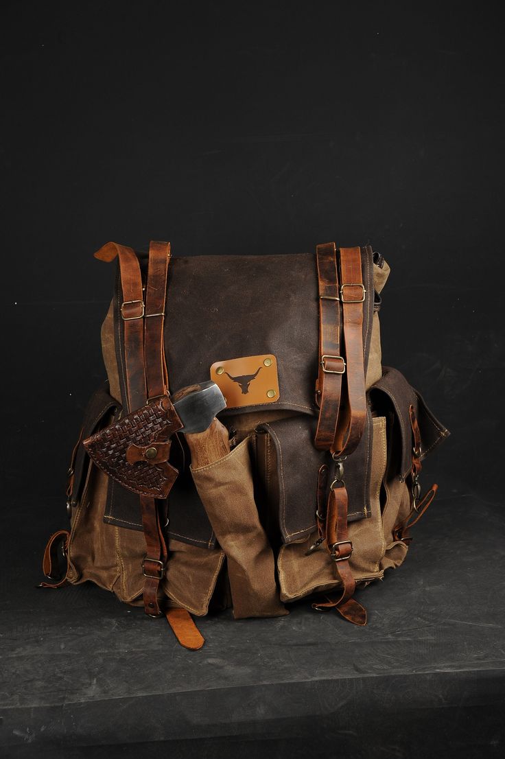 a brown and tan bag sitting on top of a black table next to a knife