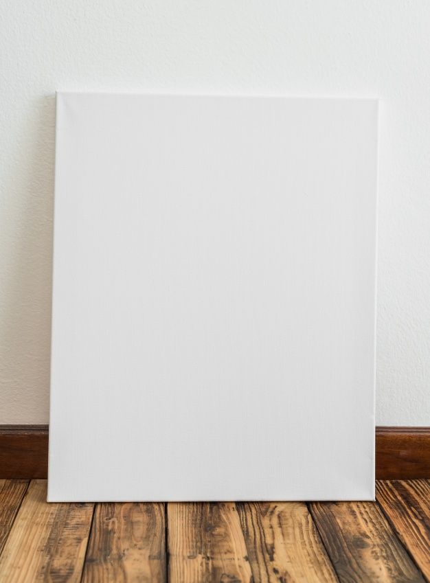 an empty canvas on the floor in front of a white wall and wood flooring