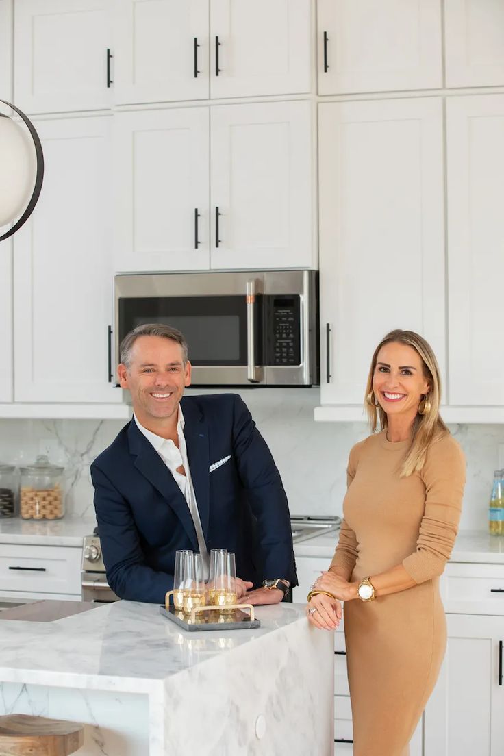 a man and woman standing at a kitchen counter