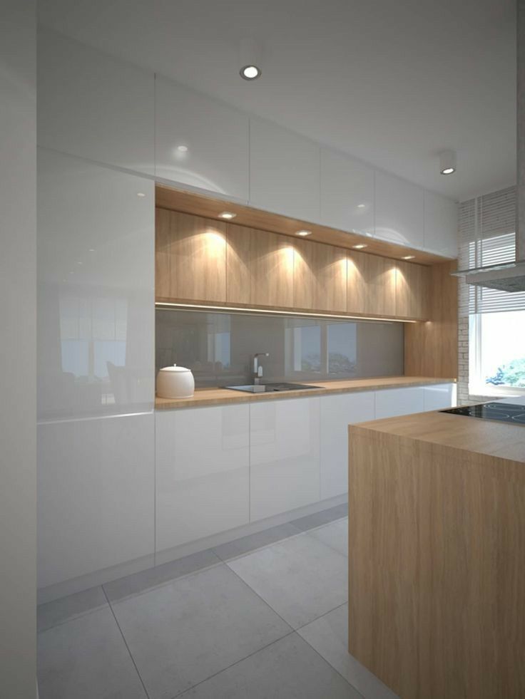 a modern kitchen with white cabinets and wooden counter tops, along with an island in the middle