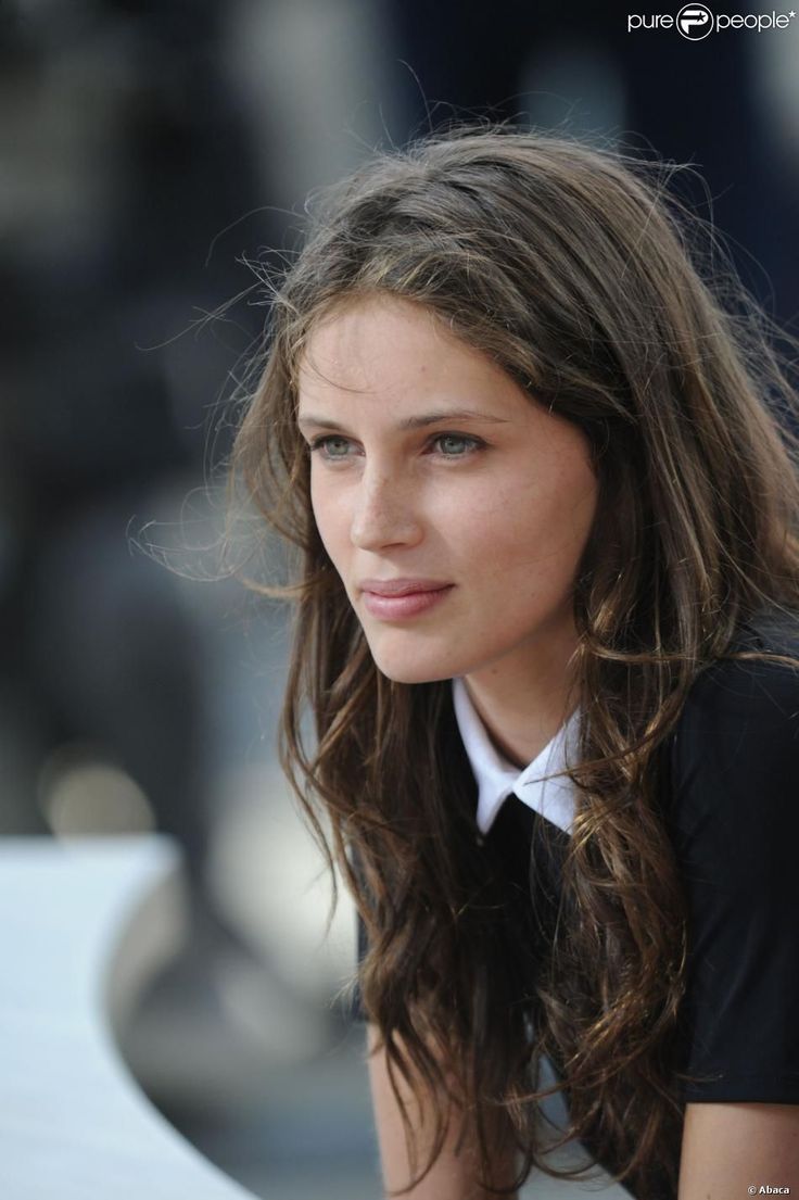 a young woman with long hair sitting down