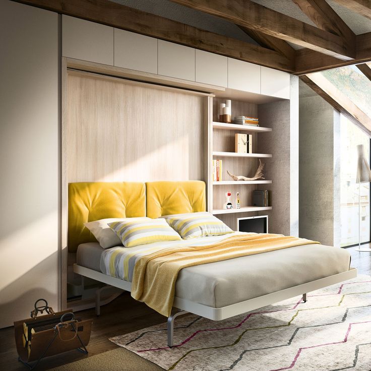 a bedroom with a bed, bookshelf and yellow headboard