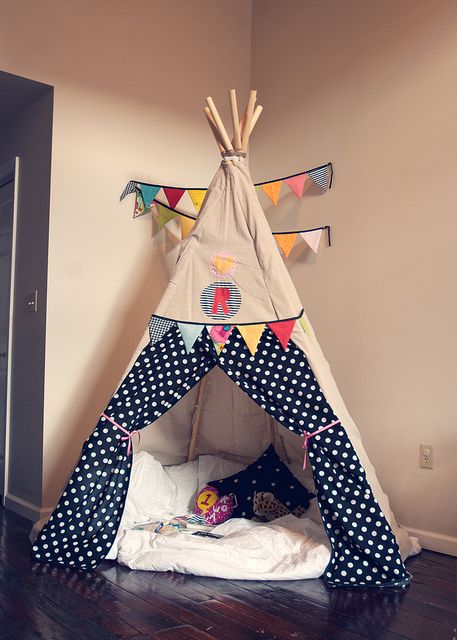 a teepee tent sitting on top of a wooden floor