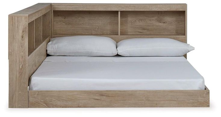 a bed with a wooden headboard and white pillows on it's sides,