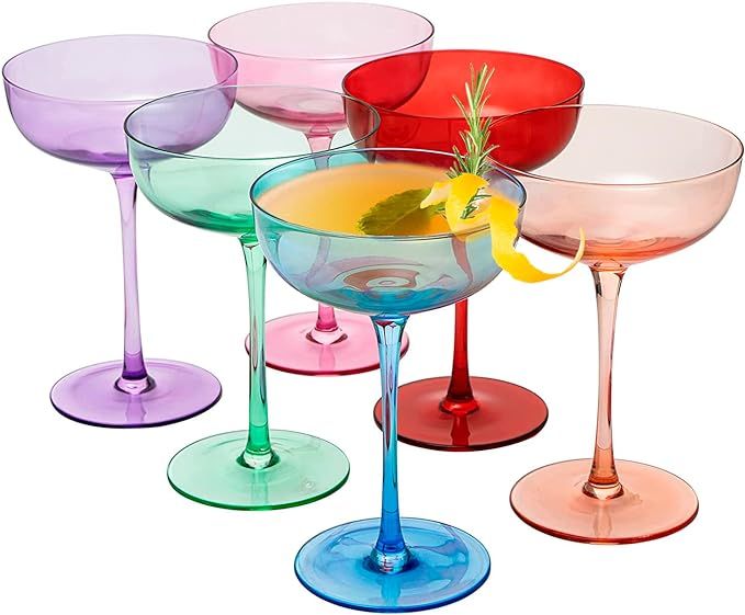 several different colored wine glasses sitting next to each other