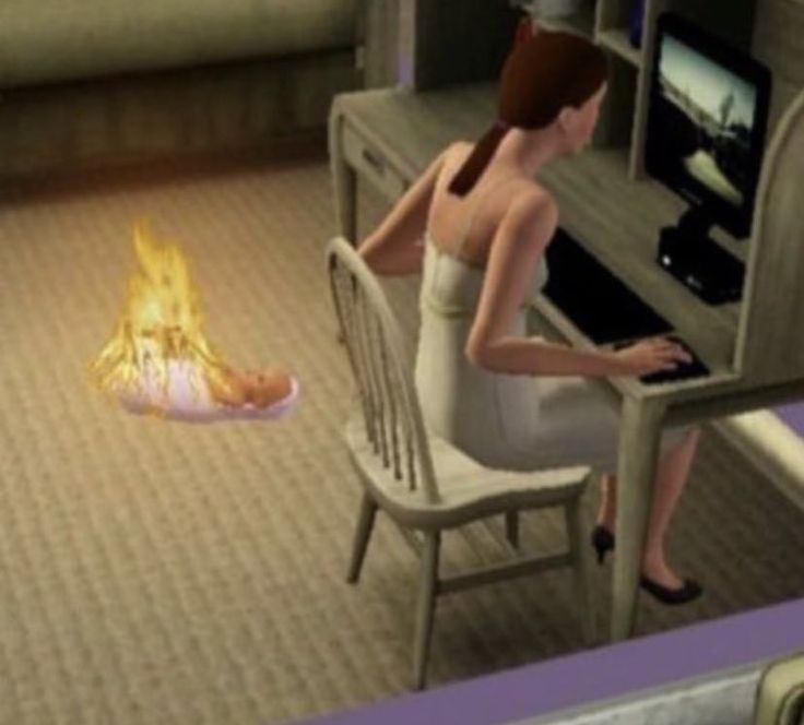 a woman sitting at a desk in front of a computer screen with a fire on the floor