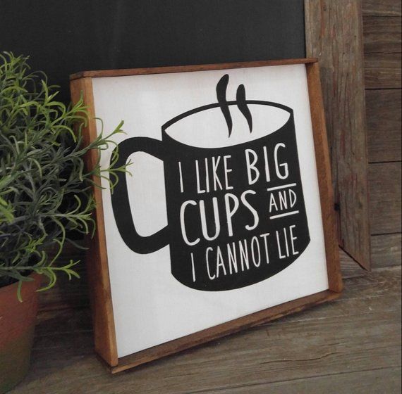 a sign that says i like big cups and i cannot't lie next to a potted plant