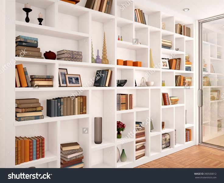 a white bookshelf filled with lots of books next to a sliding glass door