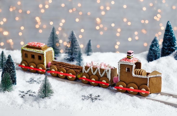 a train made out of gingerbreads is in the snow