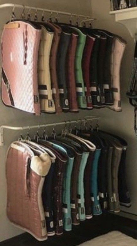 there are many purses hanging on the wall