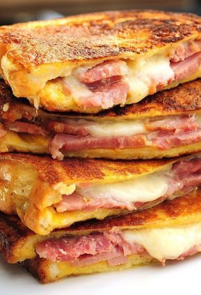 a stack of pancakes with ham and cheese