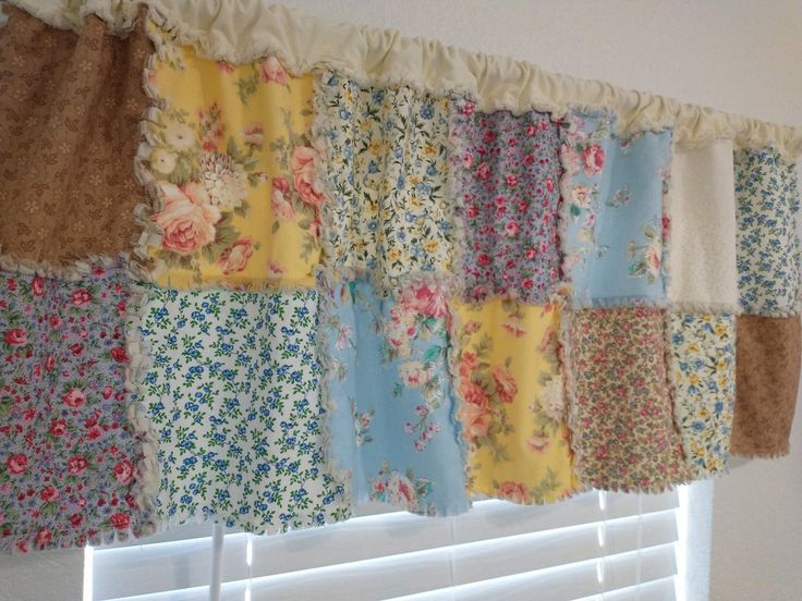 the curtain is hanging on the wall with many different colors and patterns, including flowers