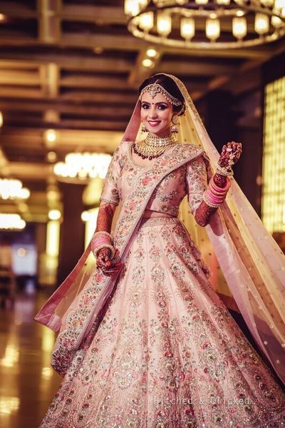 a woman in a pink and gold bridal gown