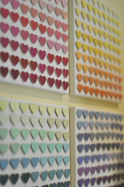 several hearts are arranged on the wall in different colors and shapes, with text that reads paint samples from hardware stores + punches = cool diy decor squares