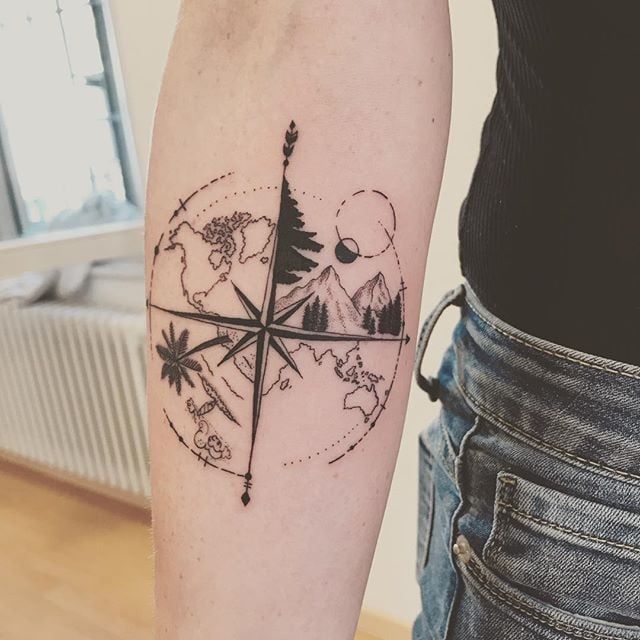 a person with a compass tattoo on their arm